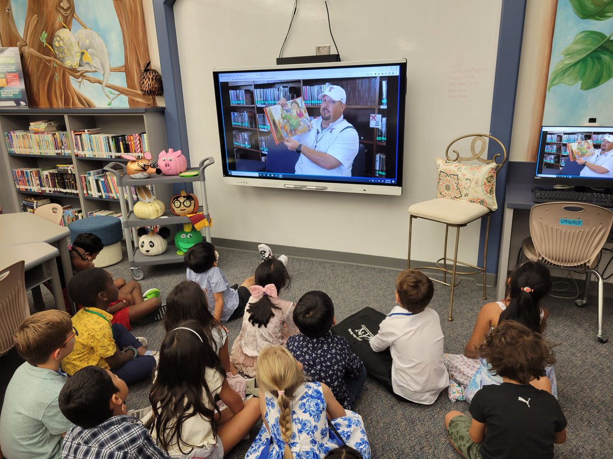 KDELibrary's tweet photo. First graders loved listening to Coach Gonzales read Little Roja Riding Hood for our Katy Reads Together program! @katy_libraries #KatyReadsTogether @TompkinsLibrary #kdepride #dragonslovetoread https://t.co/dABmFM2O9H