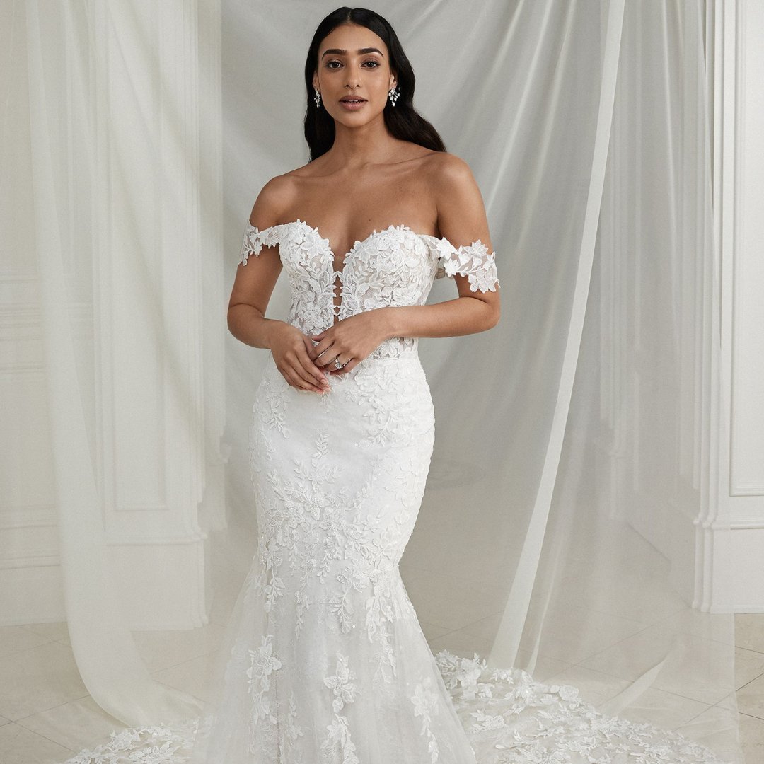 Featuring an illusion bodice with a plunging sweetheart neckline, it's paired with detachable off the shoulder straps that allows you to change up your look throughout the day <a href="/ja_bridal/">Justin Alexander</a>