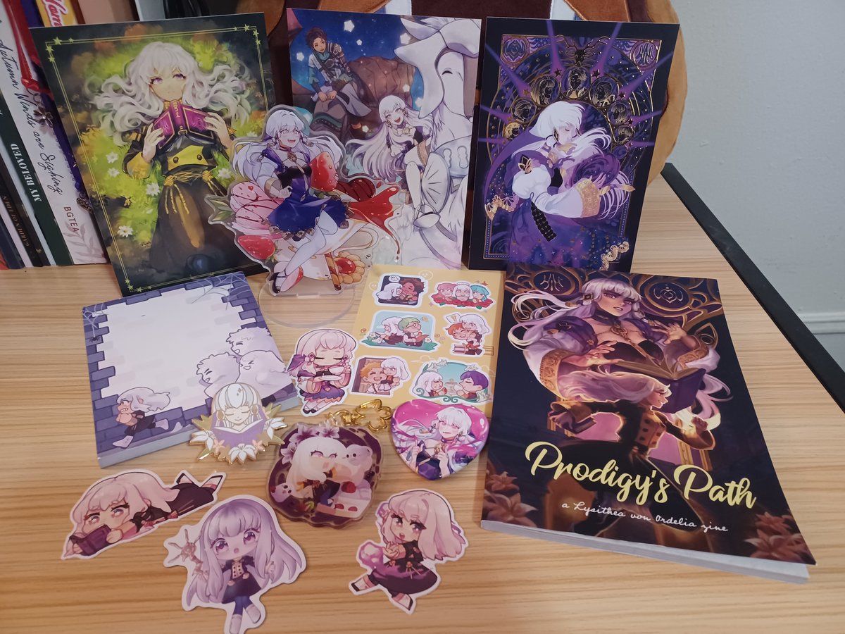 _Cavalierious_'s tweet photo. My copy of @ZineLysithea! There's another charm but i missed it in my box lmao https://t.co/158drIjDuQ