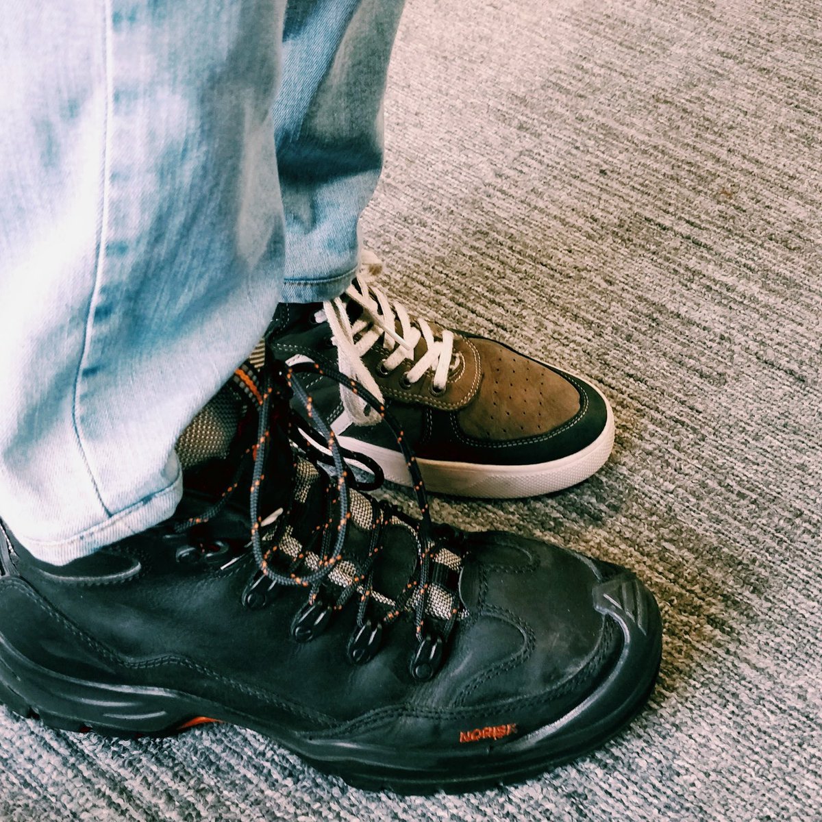 Size is relative. Both are the same size. The customer site visit Health and Safety boots are like an SUV next to my desk shoes.
