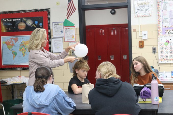 Molly Sanders demonstrates during science lab.