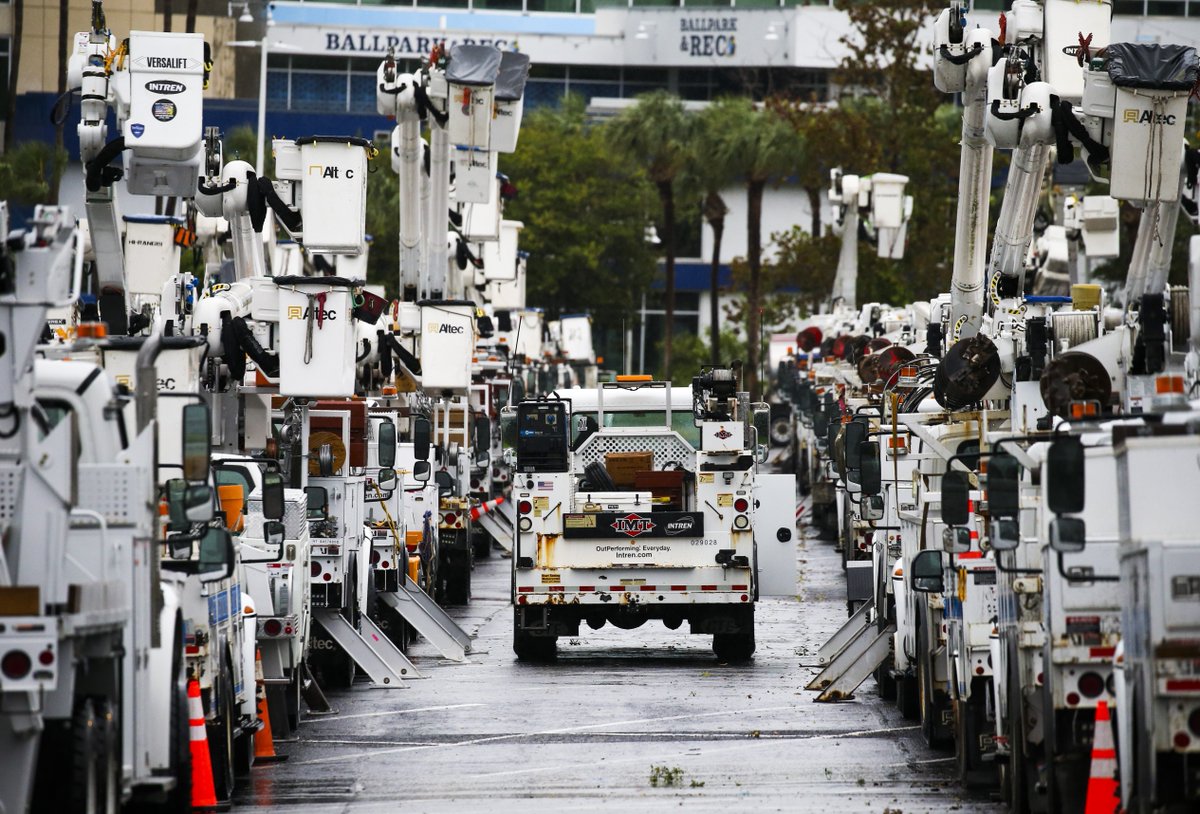 Duke Energy trucks are staged at a Tropicana Field parking lot in