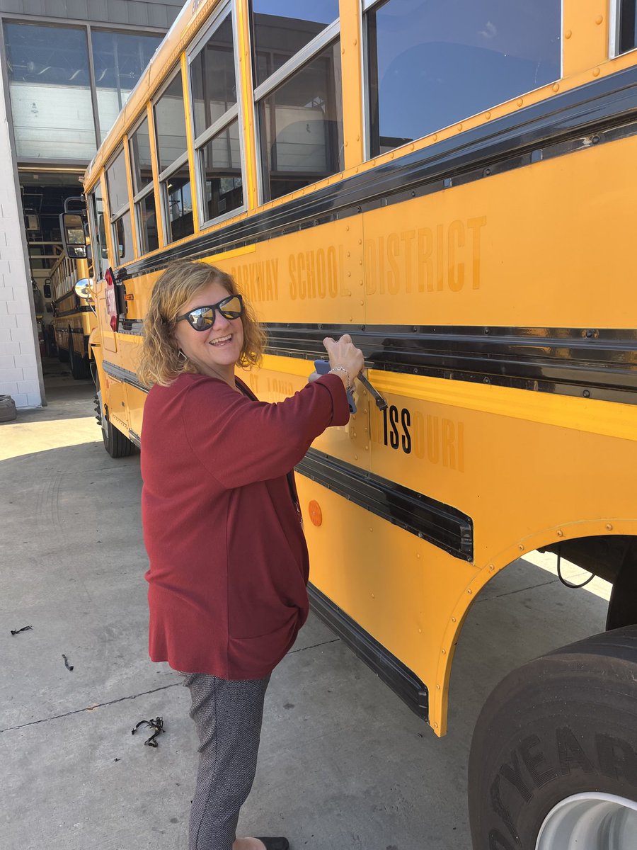 No only can Patty Bedborough 
balance  the district checkbook...
Shown here. removing parkway ids off old buses being traded for our new buses.