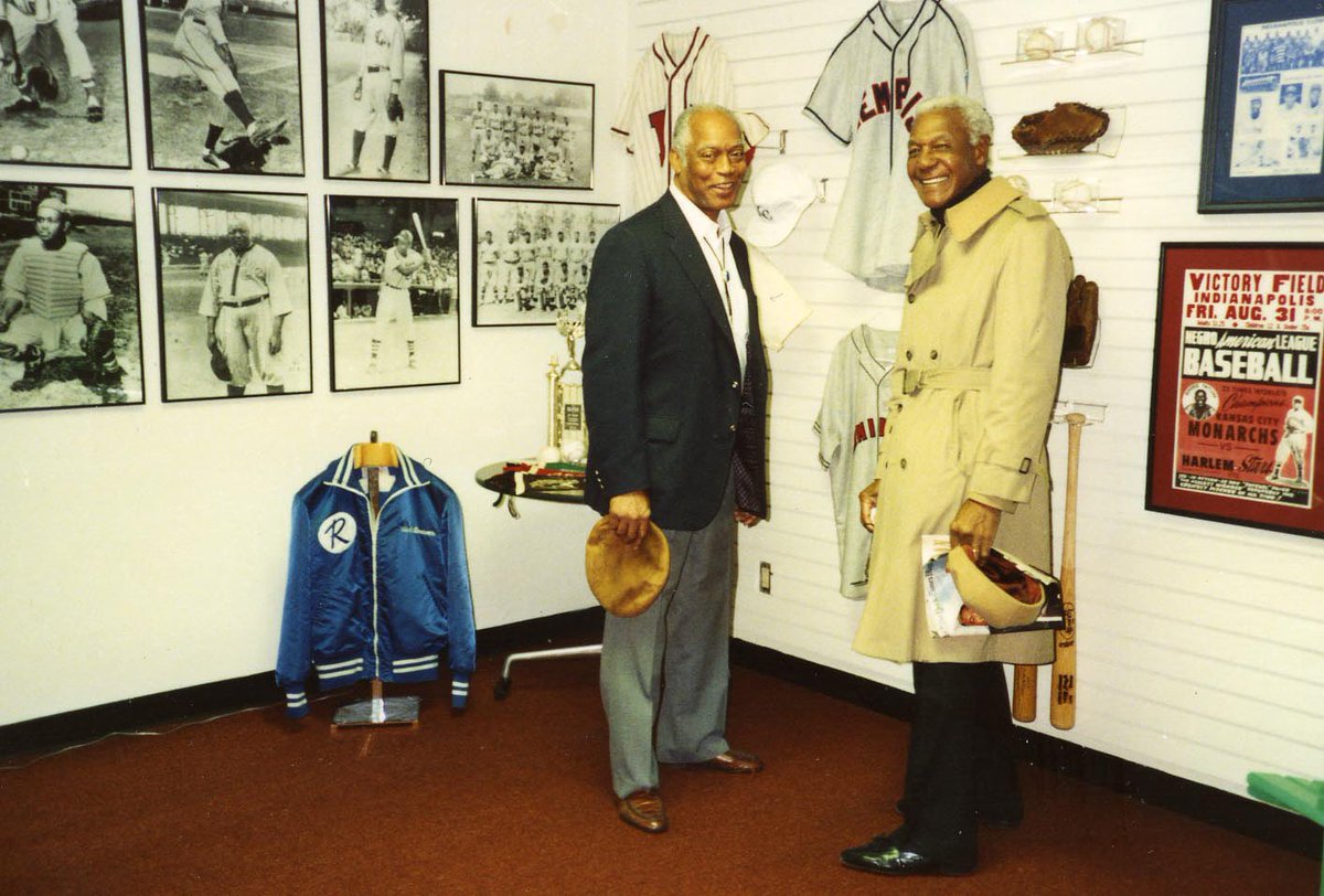 nlbmprez's tweet photo. From a one-room office to America’s National Negro Leagues Baseball Museum! Happy 32nd birthday to the @NLBMuseumKC, established OTD in 1990. That’s Hall of Famers Monte Irvin &amp; Buck O’Neil pictured in those early digs! #ThanksAMillionBuck @MLB @MLBNetworkRadio @MLBPA @Royals RT https://t.co/RoKQ2urK8M