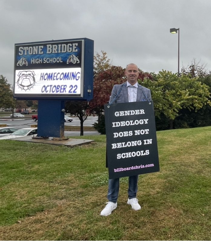 BillboardChris's tweet photo. I’m outside Stone Bridge High School in Loudoun County, where the school principal is accusing me of slurs and hate speech.

Principal Flynn, I just think we shouldn’t be teaching kids they are born in the wrong body.

They are beautiful as they are. No puberty blockers needed! https://t.co/bW8XlsibQ5