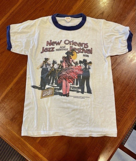 Jazznheritage's tweet photo. Check out this major blast from the past - an original 1978 New Orleans Jazz &amp; Heritage Festival t-shirt, recently donated to the @jazzfestarchive by Meisa Salaita. 

Learn more about the archive at https://t.co/uF3weMG37L https://t.co/LGsJe8u4Q8