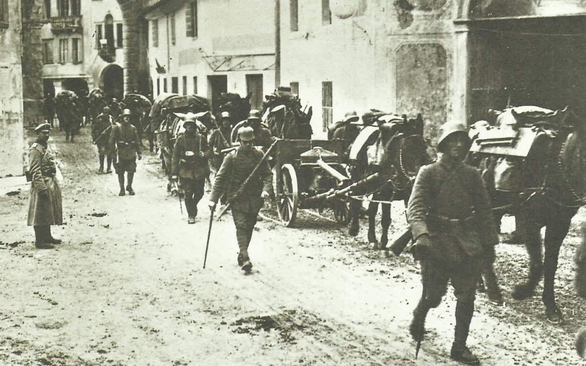 German troops march through a village in northern Italy to the front lines. #history #photography