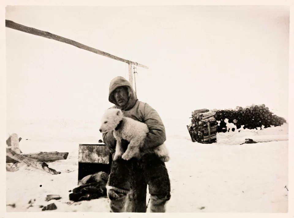 historydefined's tweet photo. Polar explorer Roald Amundsen with the polar bear cub "Marie" under his arm. Ayon Island, Russia, 1920. https://t.co/sa6X9jRiQF