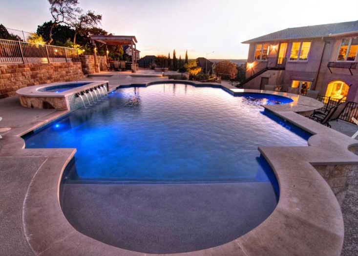 Gorgeous stone coping surrounding this custom swimming pool adds depth and visual appeal. 
#AustinPoolBuilders #AustinSwimmingPools #ReliantPools