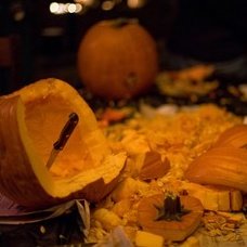 She's carving a pumpkin - looking at the ( 𝗿𝗲𝗮𝗱𝗲𝗿 ) with a big smile !

⠀❝ Haha! Looks just like you!! ❞

 It's been bludgeoned repeatedly..