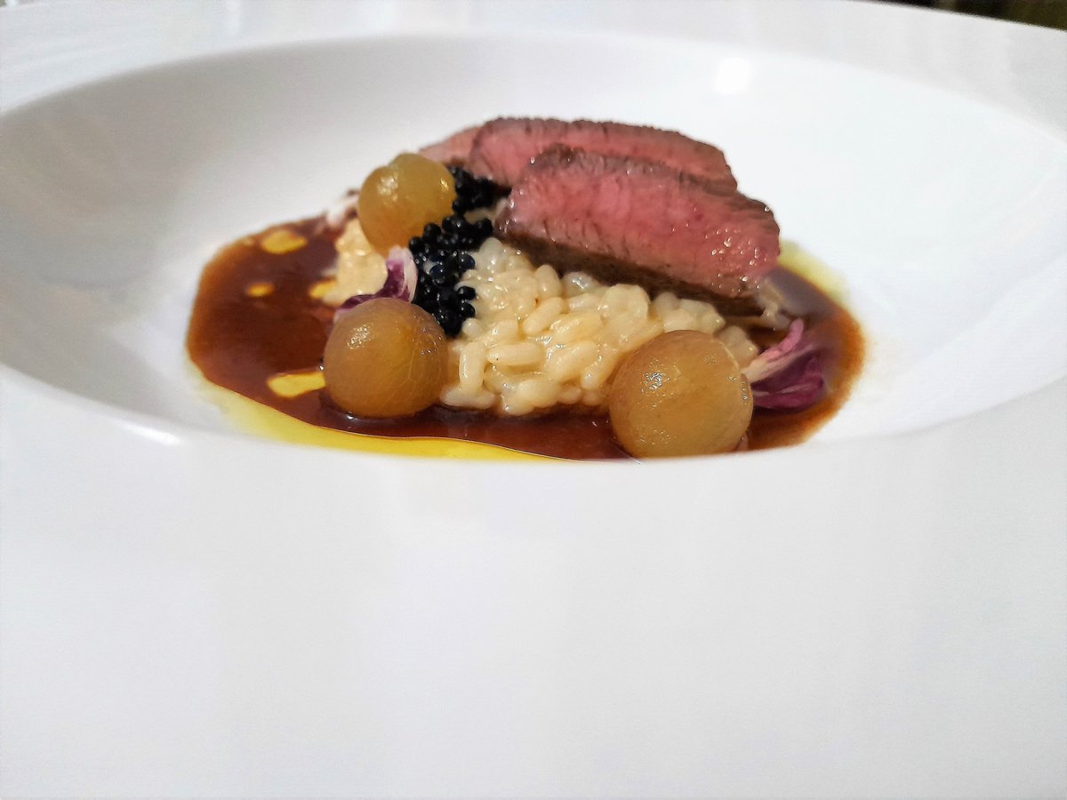 Risotto with truffled  extra virgin olive oil, meat , roti sauce, radicchio rosso, grapes and caviar (A wild dish but very tasty)