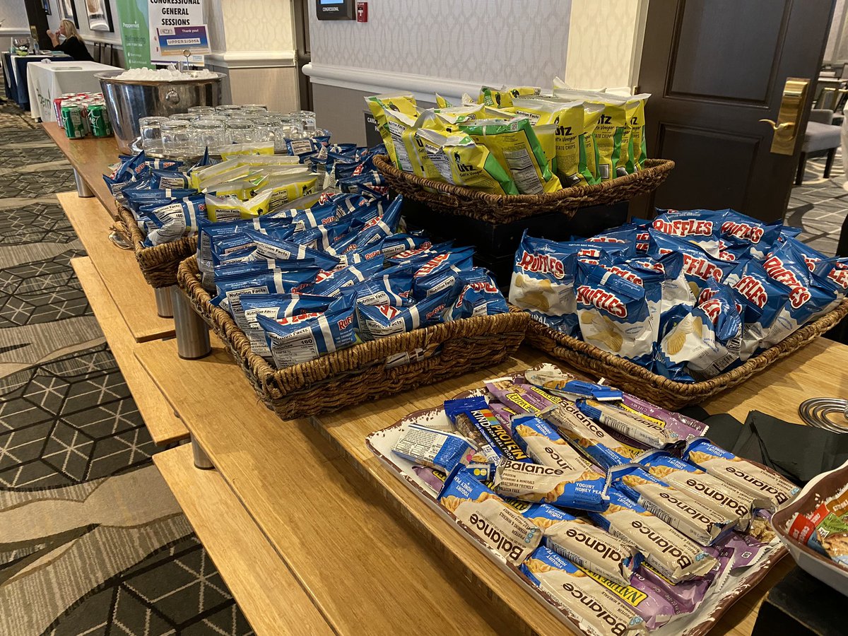 KevinH_PhD's tweet photo. A tale of two conference snack tables. On the left is the @ConsumerFed food policy conference #CFAFPC and on the right is an unnamed conference steps away at the same hotel. https://t.co/zBk5326ABO