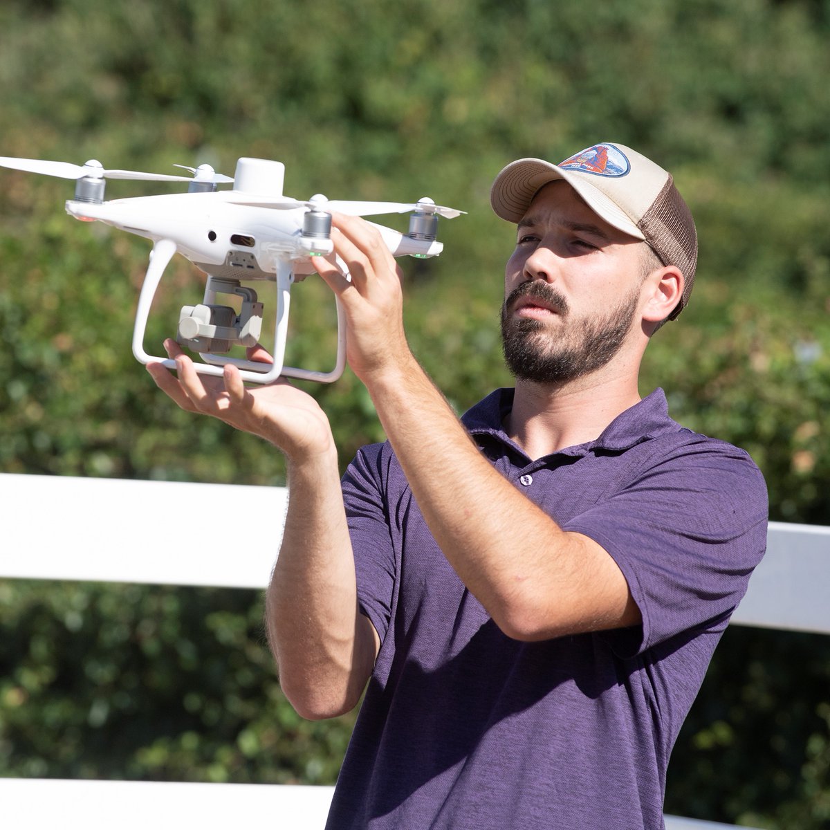 Tristan Sherman ('20, aerospace engineering), part-time lecturer, checks a drone at the Huntley Vineyard at Cal Poly Pomona.