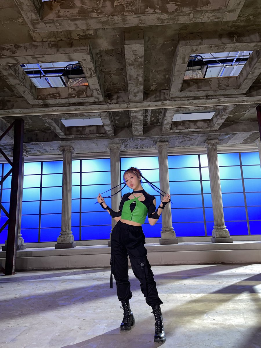 in a room that contains tall columns and abstract ornaments, with bright blue walls. i also wore a refreshing green shirt showing my appearance as a reliable shooter who was invincible. 🌠