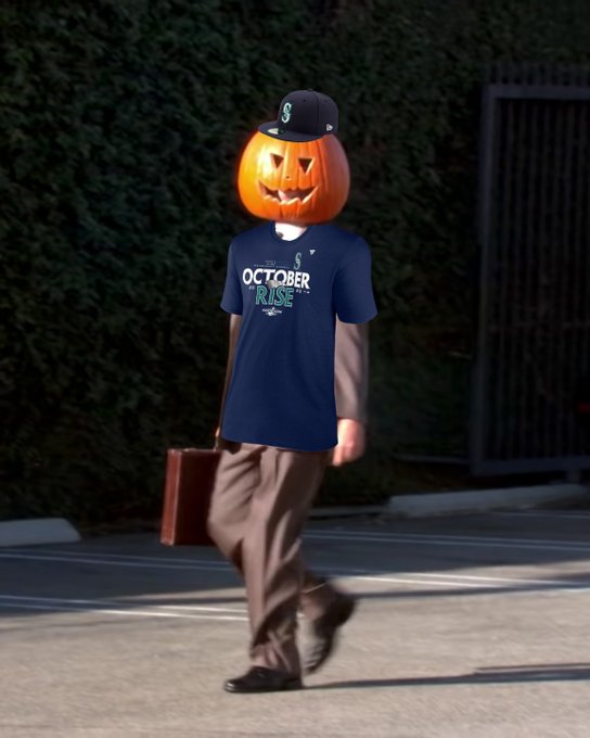 Screenshot of Dwight Schrute, with his head stuck in a pumpkin, wearing a Mariners 