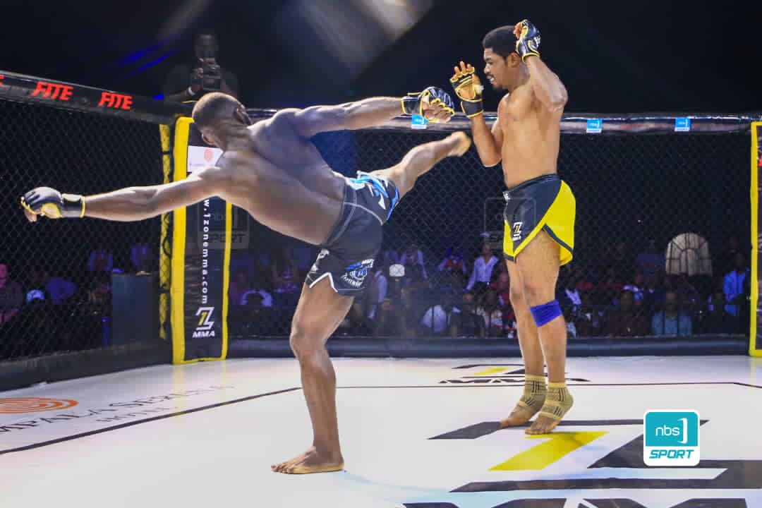 NBSportUg's tweet photo. #1ZoneMMA

Alex Matsiko commonly known as the Lion Heart is facing Emmanuel Osujji from Nigeria. 

 .@francis_isano captured the moments.

The bout is on.

Watch live the bout on @NBSportUg.

#NBSportUpdates |  #SlayOrBeSlayed https://t.co/0ows4mRCsD