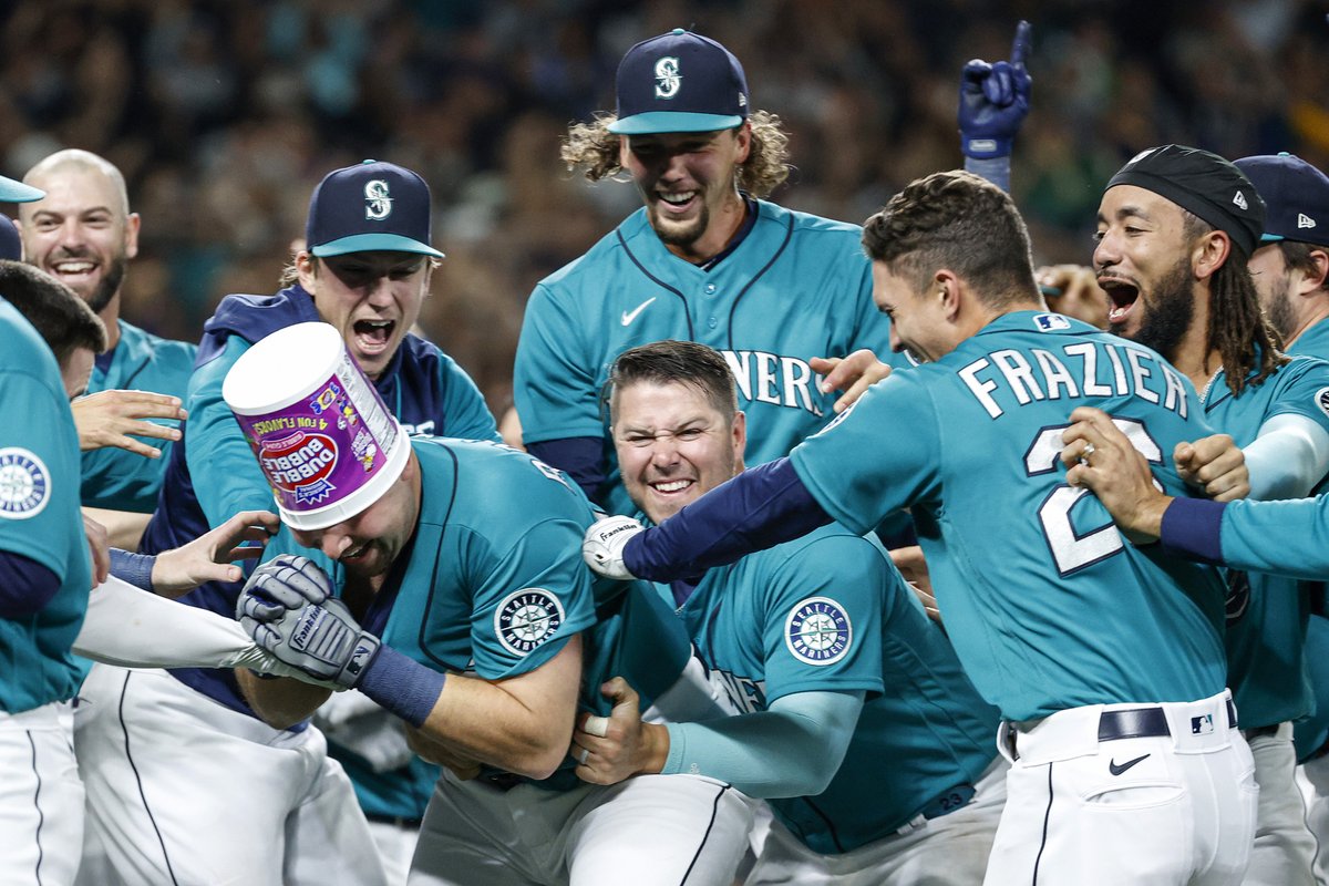 StephChambers76's tweet photo. Cal Raleigh of the Seattle Mariners hits a walk-off home run to clinch a postseason berth for the first time  in 21 years, the longest playoff drought in major North American professional sports. (Steph Chambers/Getty Images) https://t.co/1FBoP8Au8K