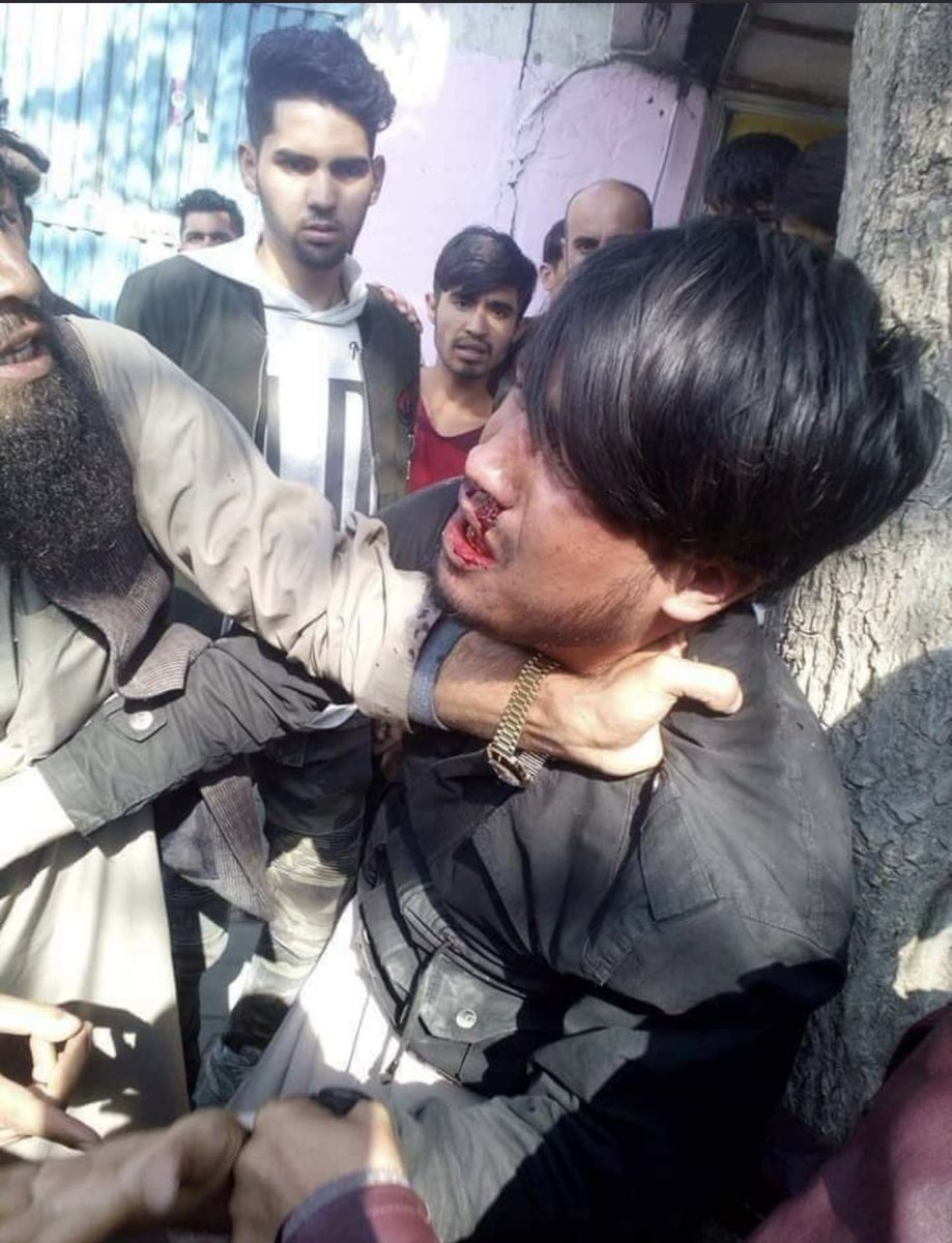 Sara37620586's tweet photo. #StopHazaraGenocide This is Rahmatulla. He lost his sister on Friday during the explosion of the Kaj educational center. Yesterday, he took it to the street to raise his voice for his grieving heart. This is how the Taliban sympathized with his mourning. https://t.co/hxofdKW18x