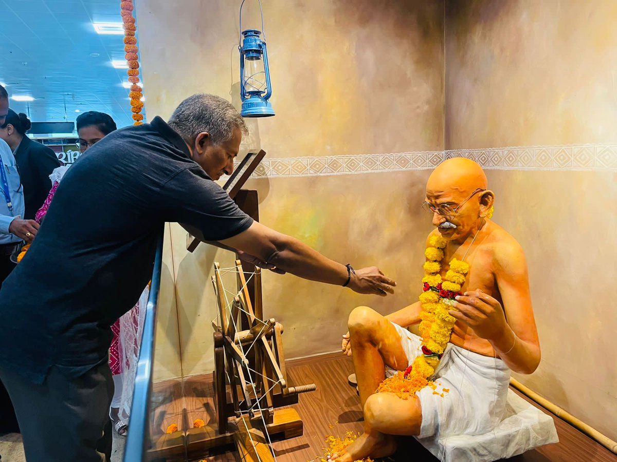 aaigoaairport's tweet photo. On the occasion of Birth Anniversary of Father of the Nation, Mahatma Gandhi, TEAM AAI GOA paid floral tributes to BAPU Display located at Departure Area, Goa Int'l Airport. The Display was decked up with Flower Decor to liven the spirits of celebrations.@AAI_Official @aairedwr https://t.co/i2EoME6kVD