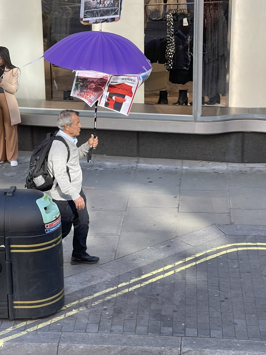 ash_q99's tweet photo. Shoutout to this man walking around central london with an umbrella display of the Iranian Resistance. #IranRevolution. We see you! 🙏🏻🙏🏻🙏🏻 #pauseforcause! https://t.co/iI6b7qwyB8
