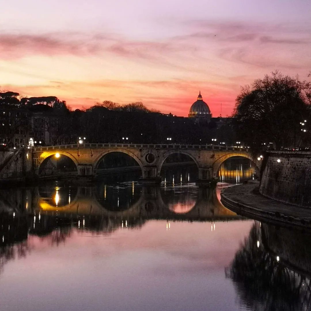 ThroughEternity's tweet photo. Sunset over the Tiber… Few things can overpower the human capacity for words as quickly as a #sunset, so this evening we’ll let the majesty of #nature speak for itself. Can you recognise the dome peeking out over the treeline in the distance?
#TiberRiver #StPeters #Rome https://t.co/2WrH632gfd