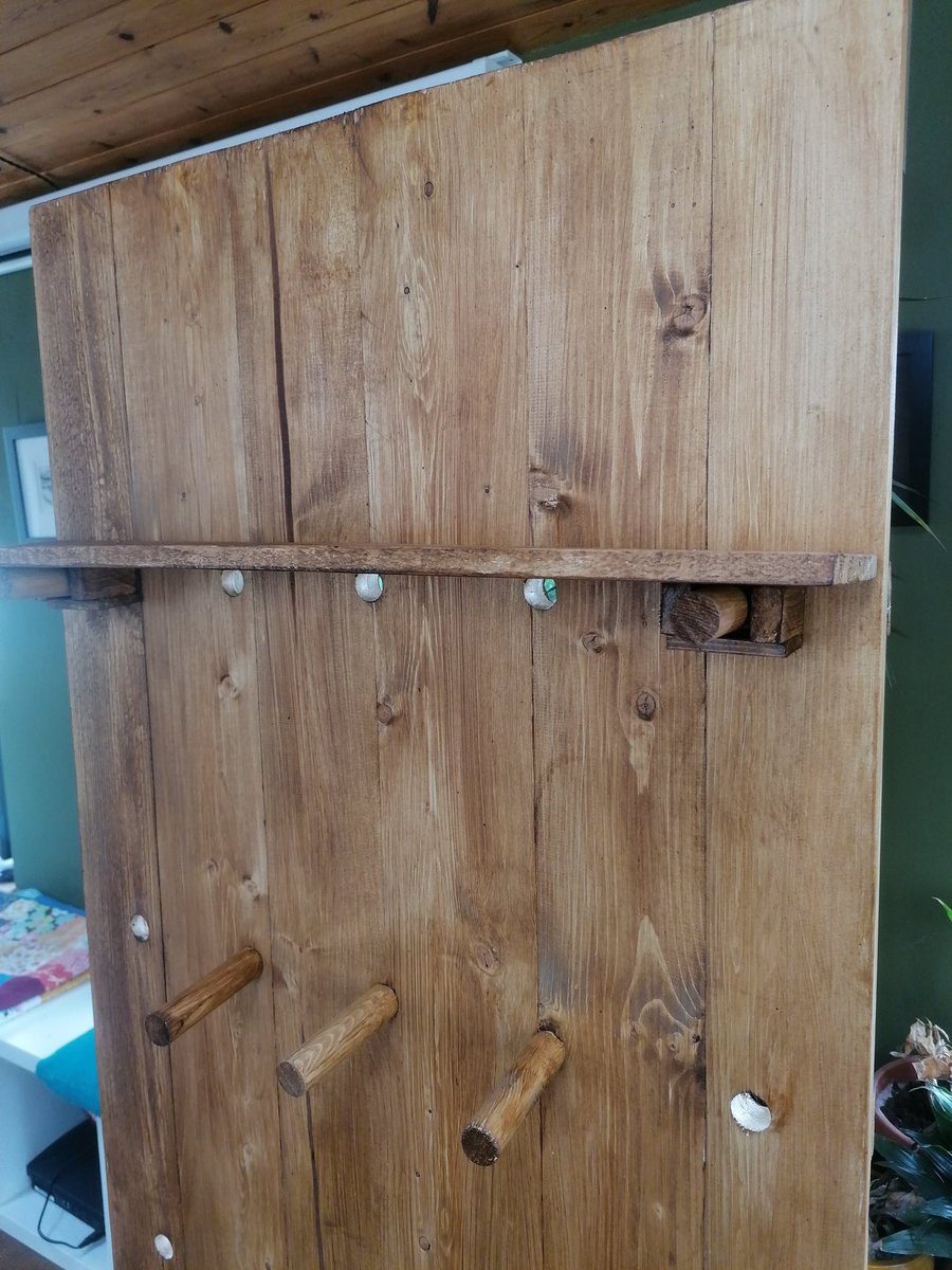 Giant free-standing wooden pegboard made with reclaimed wood stained in dark oak to bring out the woodgrain. Custom ordered for Kopi and Co. dog accessories company for vertical display for markets.