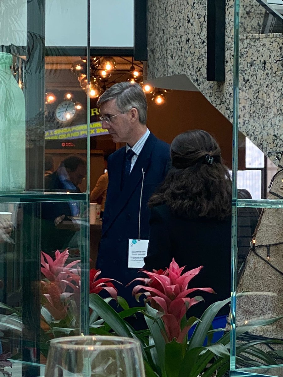 Jacob Rees Mogg wears his conference pass in an unconventional way because of his opposition to lanyards (2022)
