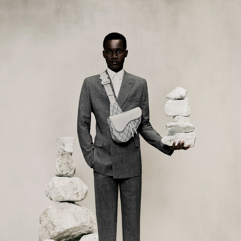 Dior's tweet photo. Visit our website or your nearest Dior boutique to discover the timeless ‘CD Diamond’ motif of the men’s Winter 2022-2023 collection by Kim Jones, as seen on the iconic ‘Dior Saddle’ bag and ‘B23’ sneakers.