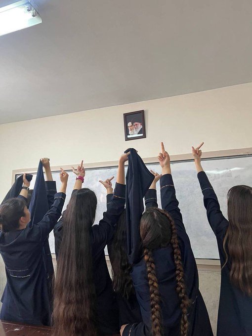 Iranian schoolgirls show the middle finger to the regime's supreme leaders
