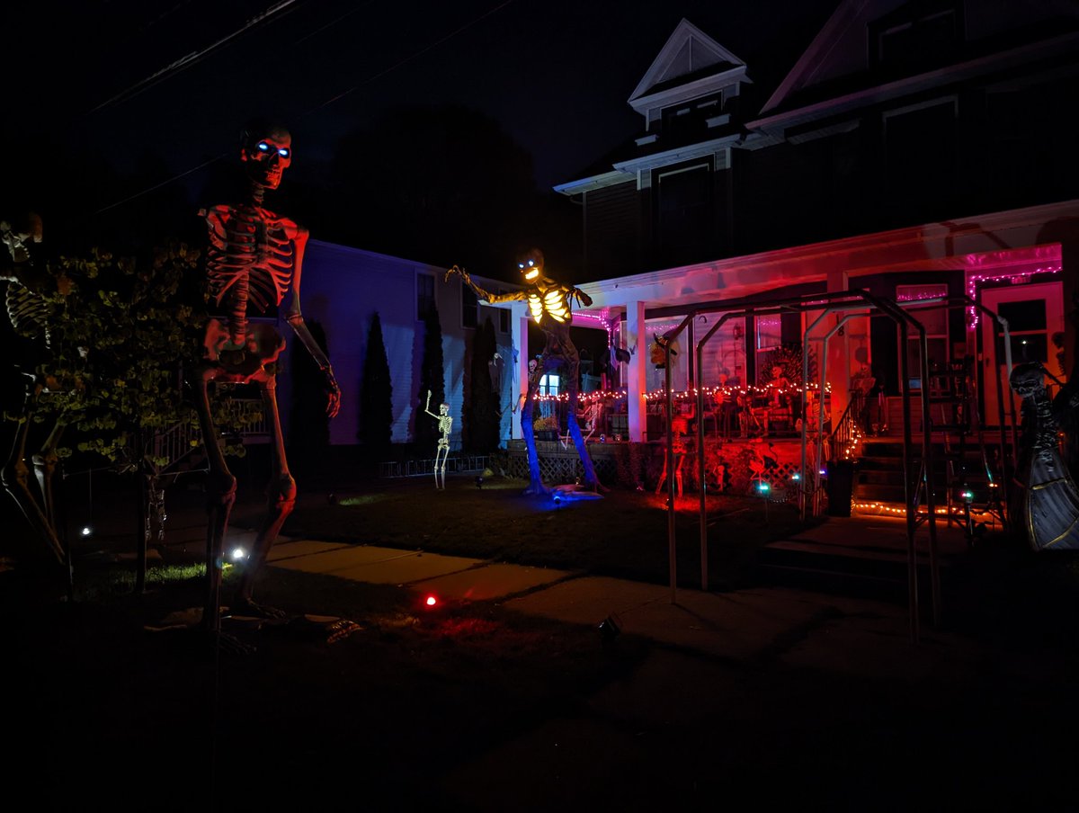 MephistoMori's tweet photo. About halfway done decorating. Still gotta get on top of my porch. Set my gravestones and cemetery fence, sling some cobwebs and more lighting around, pose more skellingtons, set up the 15 footer (who's waiting on clothes) and naturally put an 8' spider on my roof. #SpookySZN https://t.co/5GKB4yOmUy