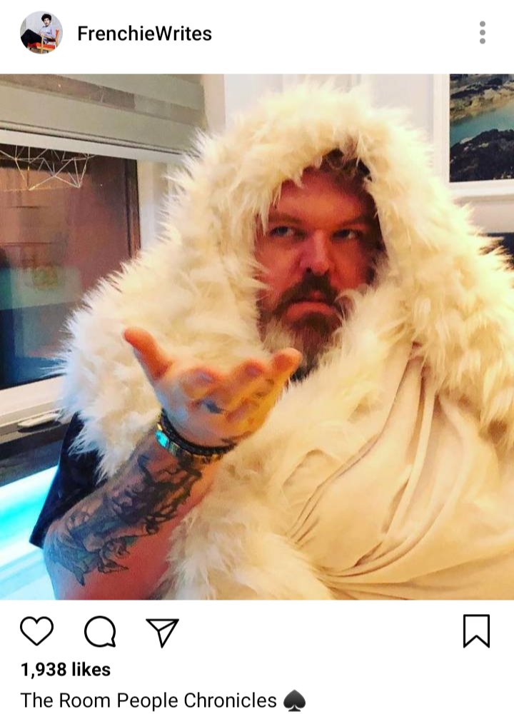 Frenchie's IG: photo of John wrapped in a fluffy blanket. Caption reads "The Room People Chronicles" 