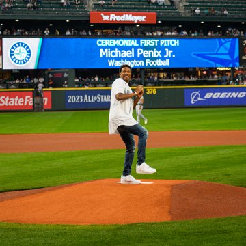 University of Washington Huskies Quarterback Michael Penix Jr. throwing out the first pitch. 