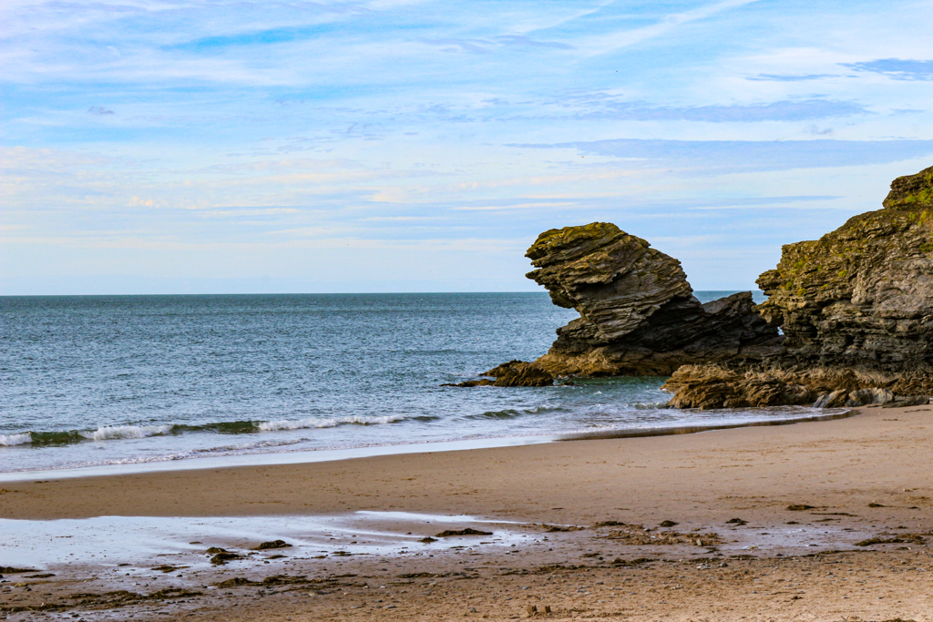 Jones8Pamela's tweet photo. Late sunshine at Llangrannog and Carreg Bica rock - the legend states that it is the tooth of Bica a giant with toothache! @ItsYourWales @visitceredigion @WelshCountry @WalesCoastPath #peoplewithpassion https://t.co/B8qgzpCfKZ