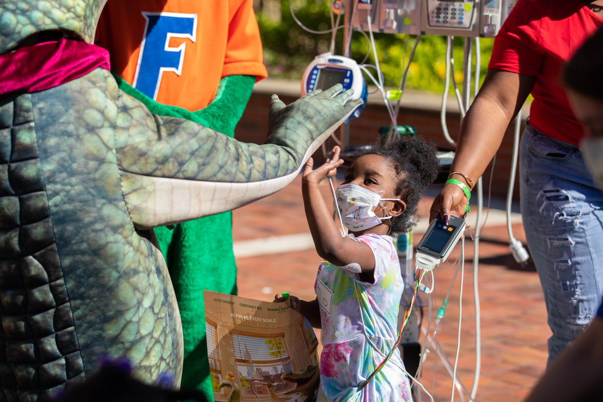 UF's tweet photo. Florida: The only place on Earth where crocodiles and alligators coexist 🐊

Beloved reptiles @LyleCrocodile and @AlbertGator joined @PresidentFuchs and Mrs. Fuchs at the @UFHealth Children's Hospital today to spread joy to our pediatric patients. 🧡💙 https://t.co/RnsEvmJ2oH