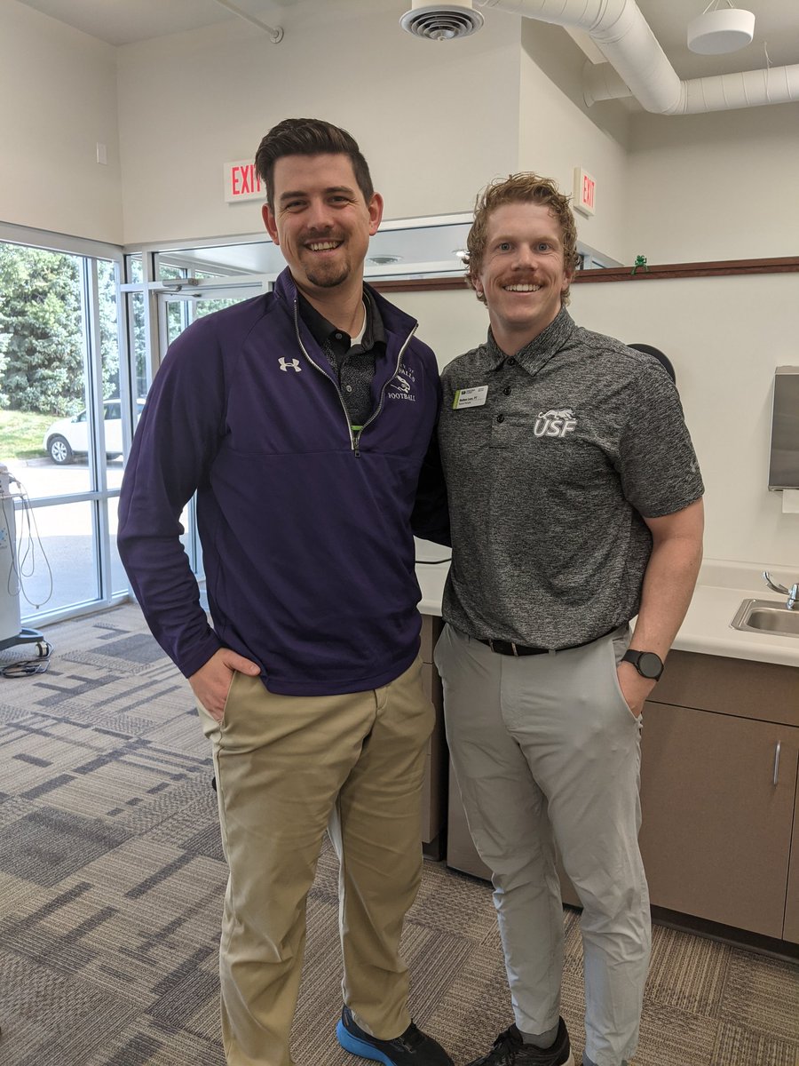 Two DPTs working at <a href="/TheIowaClinic/">The Iowa Clinic</a>. One from Augie (<a href="/DP3_ATC/">Dylan Peters</a>) and one from USF. Loser has to wear the other team's colors. Thankful for @USFCooFootball for pulling off the win so I didn't have to wear blue and gold. 💪😤 Proud to be a Cougar!