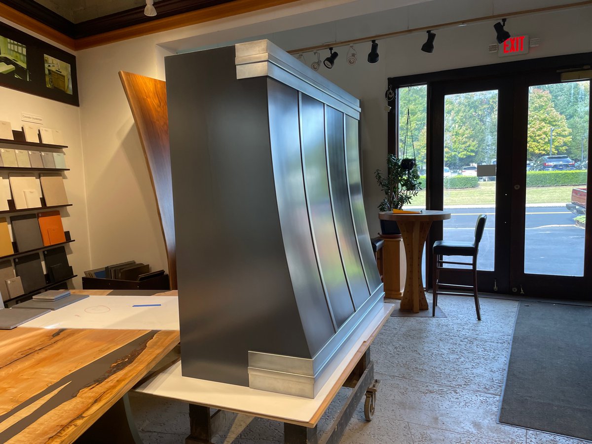 Enamel finished #stainlesssteel #rangehood with #custom artisan-cast #zinc strapping. Only at Brooks Custom