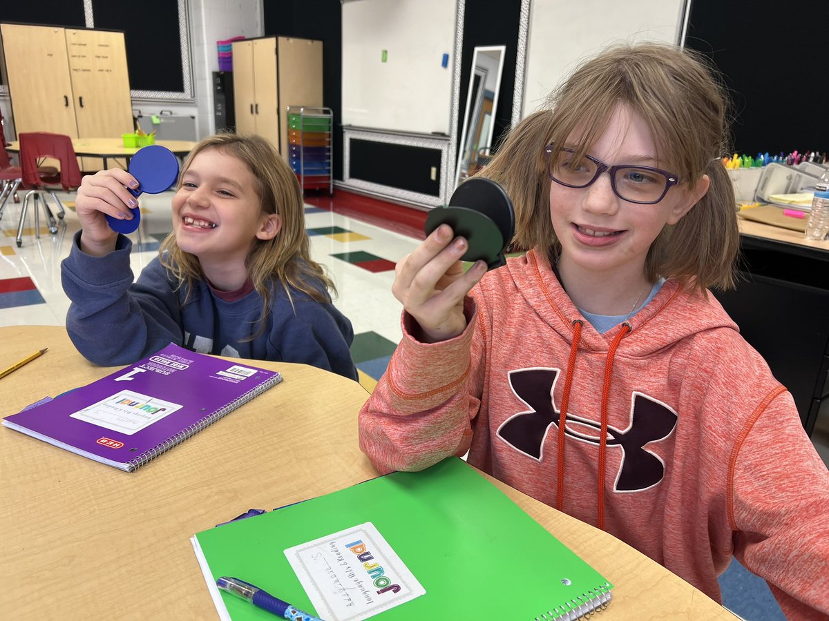 These students are checking their mouth formations in a mirror to make sure they are articulating the sounds correctly. Phonics is so much fun!