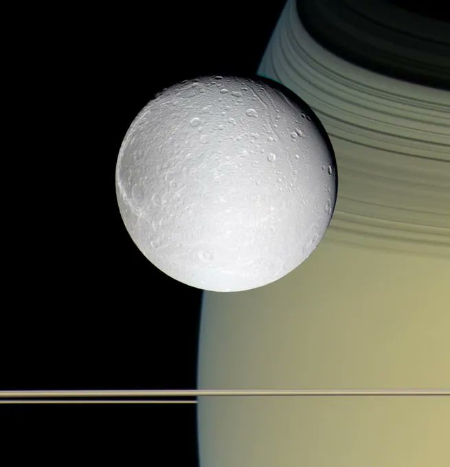 NASA The Cassini spacecraft took this view of Saturn's moon Dione in October 2005, with the tranquil gold and blue hues of Saturn in the distance.