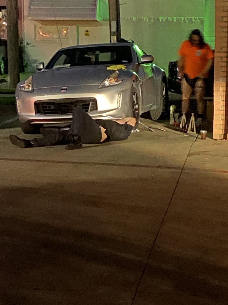 Do you think this guy in hot pants in my parking lot can really fix this car?