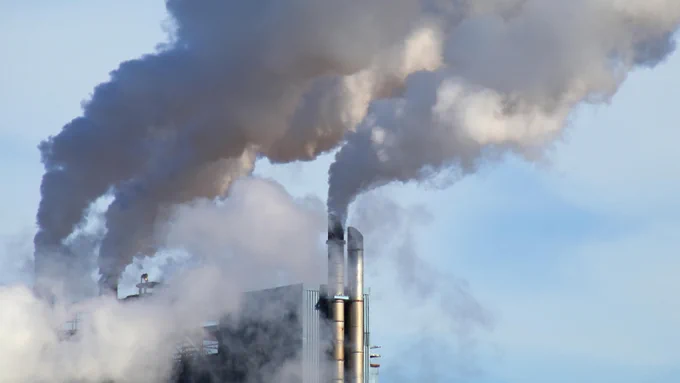 Image of steam coming out of factory pipes.