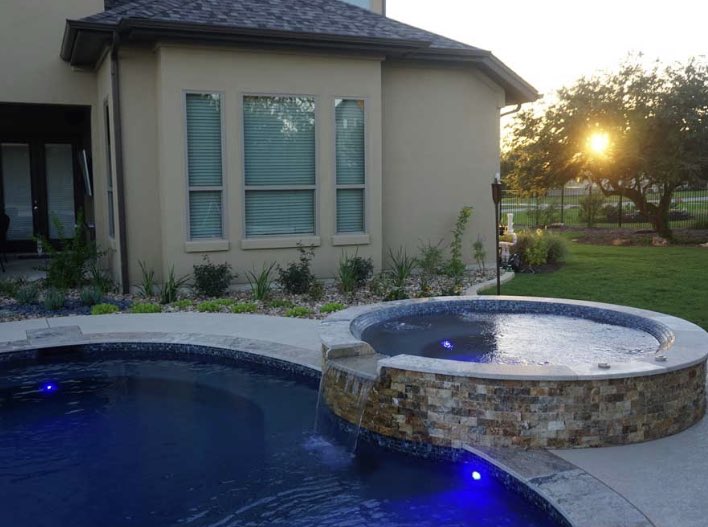 This custom pool and spa perfectly compliments this beautiful house. #AustinPoolBuilders #AustinSwimmingPools #ReliantPools