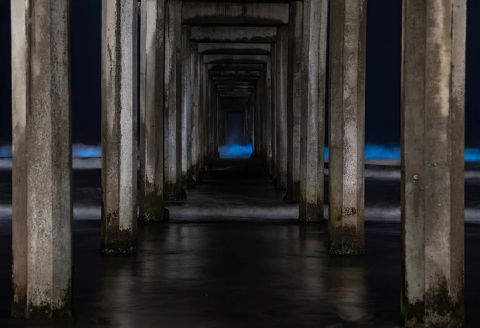 bright blue waves at night at Scripps pier 