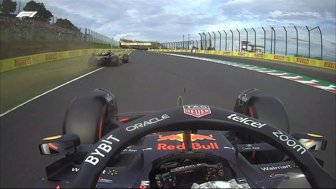Onboard shot of Max Verstappen's car, with Lando Norris' McLaren seen just ahead on the grass.