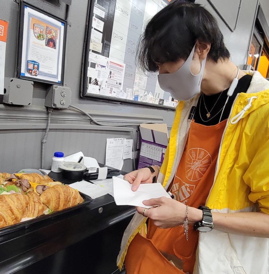 SharksBri8's tweet photo. Some more of our closing cashiers getting their grub on. Our Head Cashier Holly helping Miguel pick out his sandwich. Reo grubbin on a good pick, too. #D50 #PacNorthProud #HomeDepot #livingtheorangelife #CAMWeek https://t.co/uCzCcrvpm9