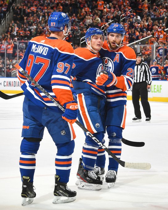 McDavid, Barrie, and Draisaitl celebrating a goal at Rogers Place. 