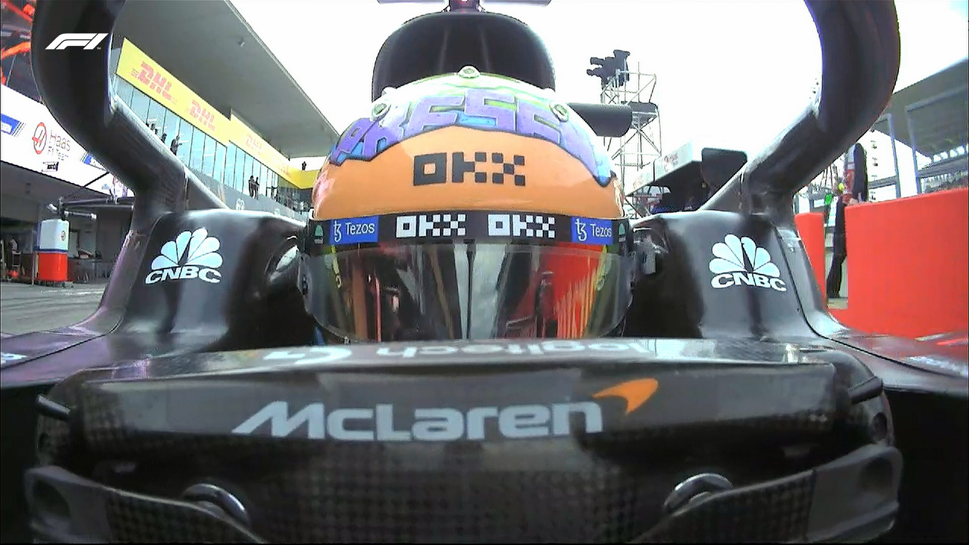 A front-facing camera angle of Daniel Ricciardo as he drives into the pit lane at the end of Q2. His steering wheel, helmet and halo can all be seen clearly.