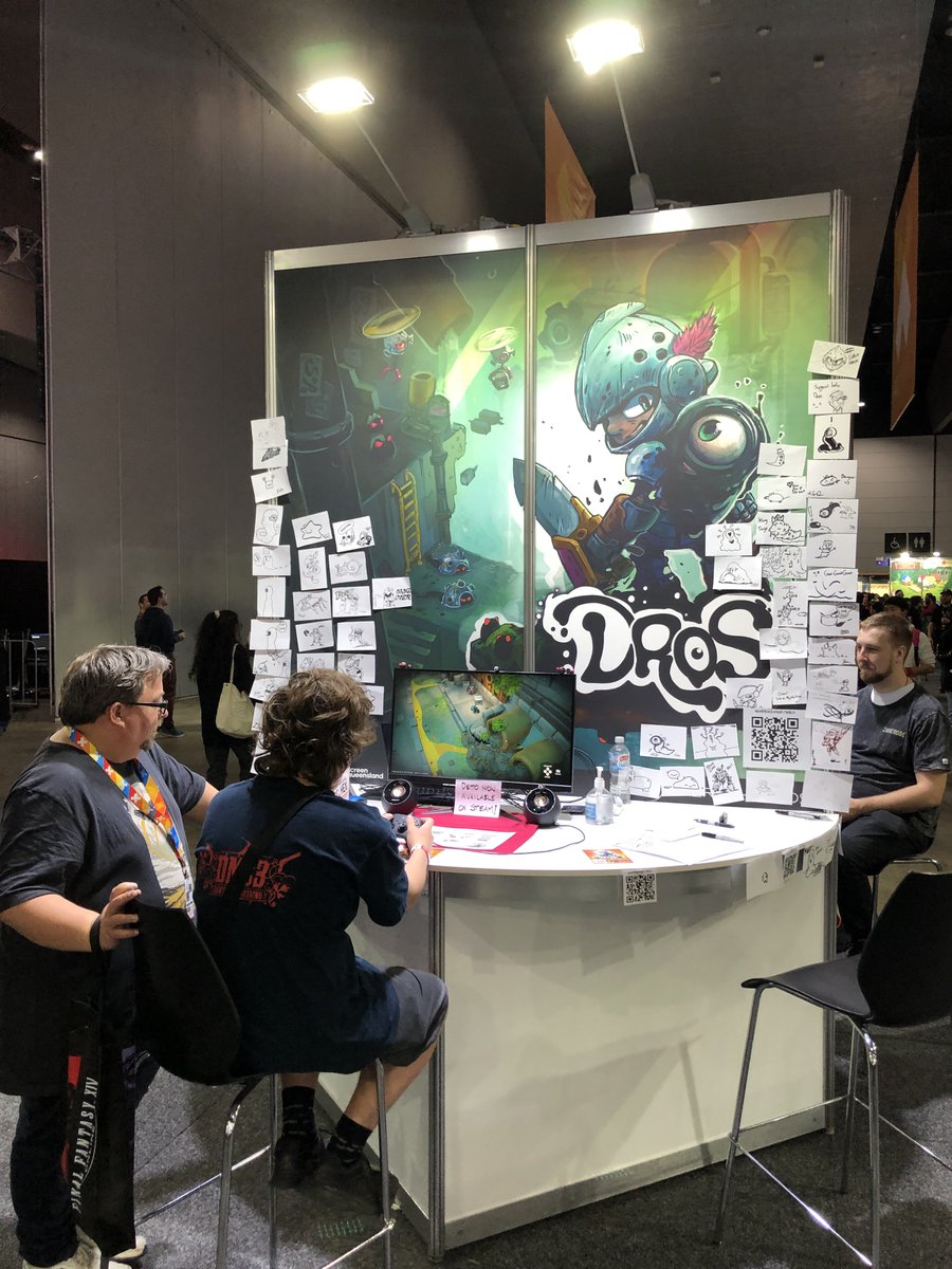 DROS_game's tweet photo. It's our final day @PAXAus 

Our draw a Dros wall is growing with some spectacular art! Come and say hi to the team and give Dros a play.

#IndieGameDev #indiegame #gamedev https://t.co/Q89Aesa8uq