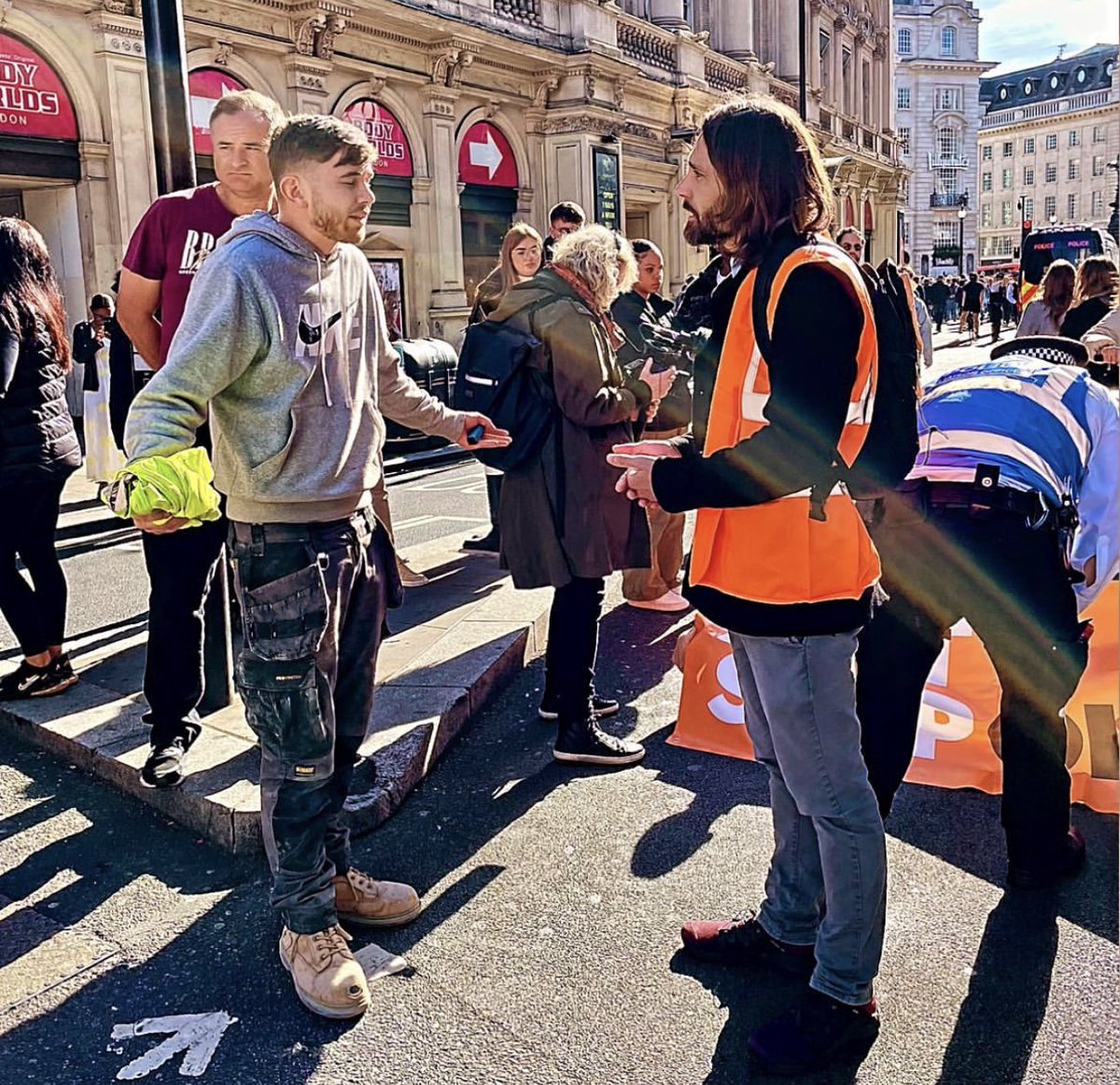 This is quite the photograph. A lad in his work gear pleading with a member of the unwashed middle classes to clear the road and let him go home. Who on earth do these selfish tossers think they’re winning over to their anti-human cause?