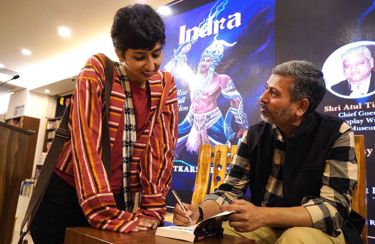 In this picture I am getting my dad's book- 'Indra:The rise and fall of a hero' signed by him while he admonishes me for spending money on the book since he had already gifted me one. Felt really proud that day!