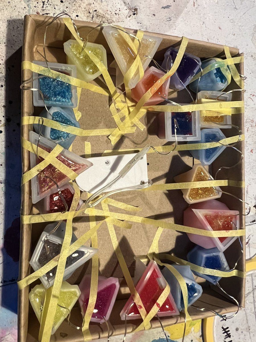NavajoBirdsong's tweet photo. Still playing with #resin.. I’ll know in 24 hrs if this idea of setting this wee lights string  in #polydice shapes will work!😳😜🫣 #dnd Christmas decs!! https://t.co/DKlu3ZcSYt